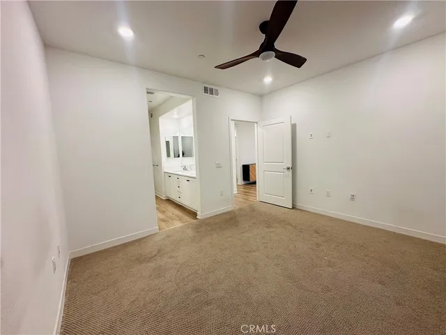 a view of a livingroom with a ceiling fan and window