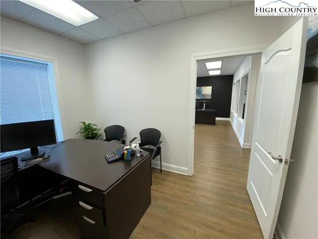 a view of a workspace with furniture and bathroom