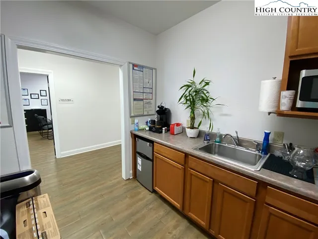 a kitchen with sink and cabinets