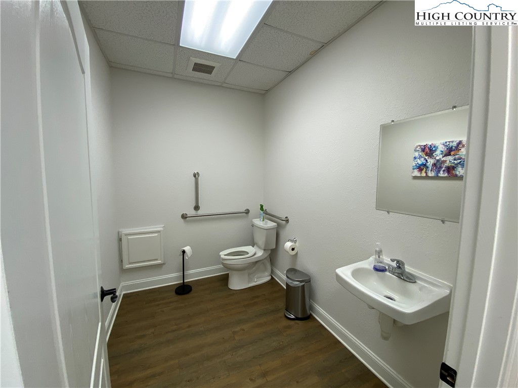 875 Mt Jefferson Road, Unit 2 West Jefferson, NC 28694 - Photo 10 of 12 a bathroom with a sink a toilet and a mirror
