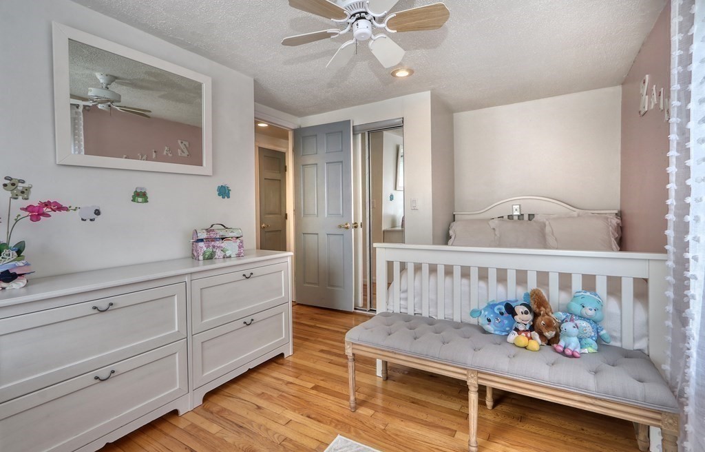 3 Oak Tree Road Dedham, MA 02026 - Photo 11 of 23 a bedroom with furniture and baby crib