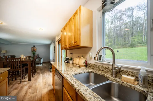 a kitchen with a sink and a large window