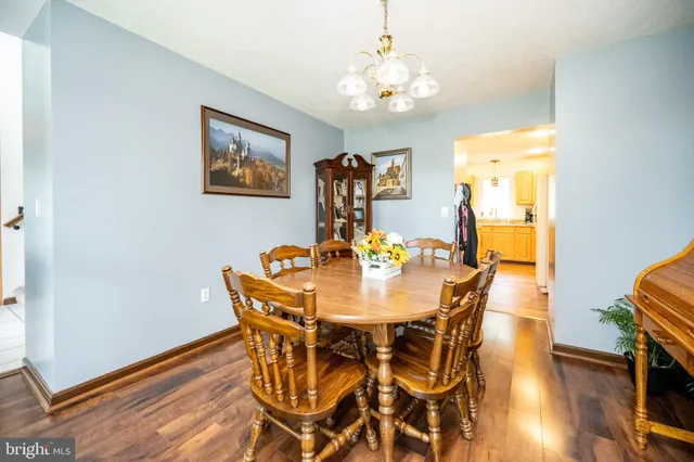 a view of a dining room with furniture wooden floor and chandelier