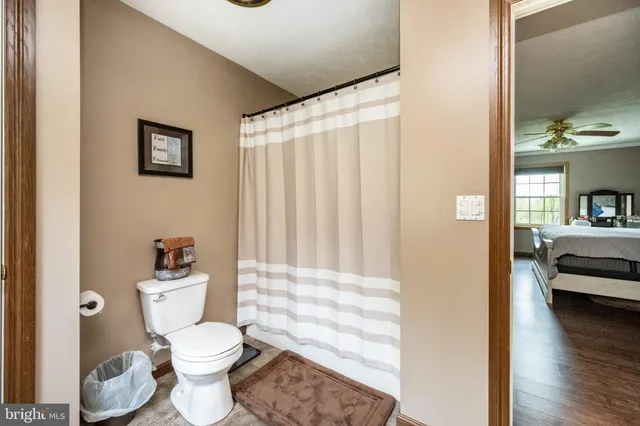a bathroom with a toilet a sink and a shower