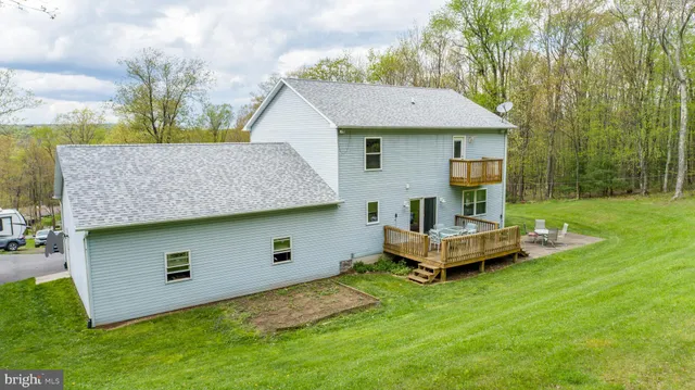 a aerial view of a house with a yard and sitting area
