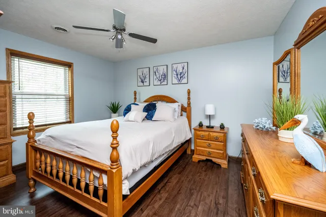 a bed sitting in a bedroom next to a window