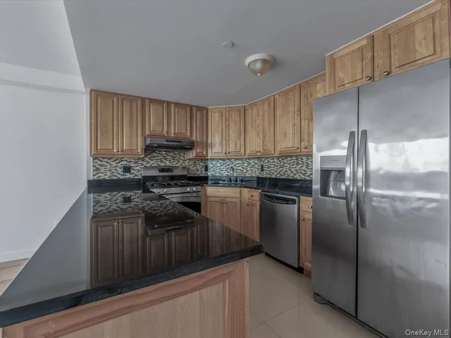 a kitchen with granite countertop white cabinets and white appliances