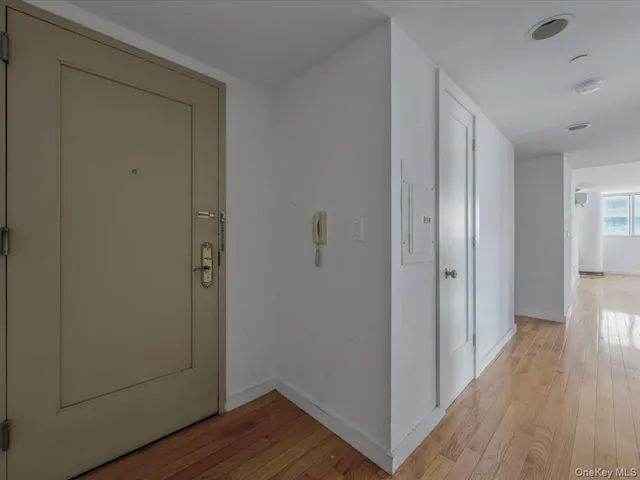a view of a hallway with wooden floor