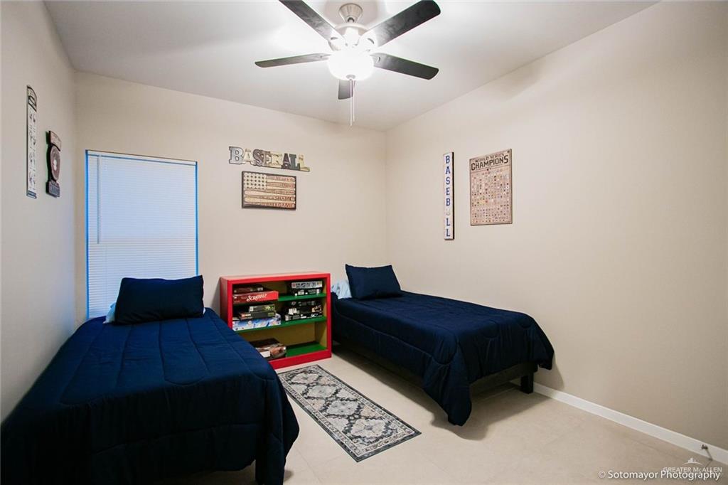5601 Swallow Avenue, Unit 2 McAllen, TX 78573 - Photo 8 of 15 Bedroom with ceiling fan and baseboards