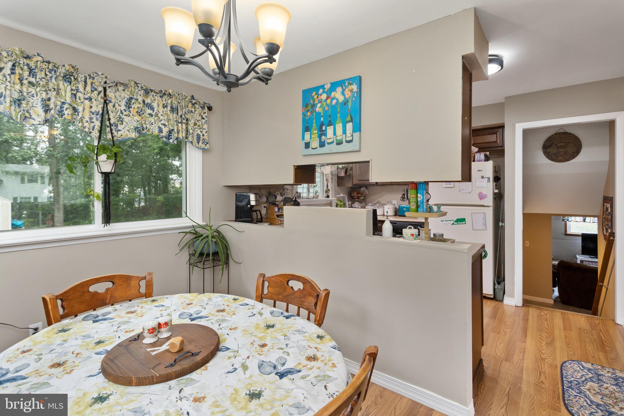 517 8 Street Riverside, NJ 08075 - Photo 8 of 29 a kitchen with a refrigerator a stove a sink dishwasher a dining table and chairs with wooden floor
