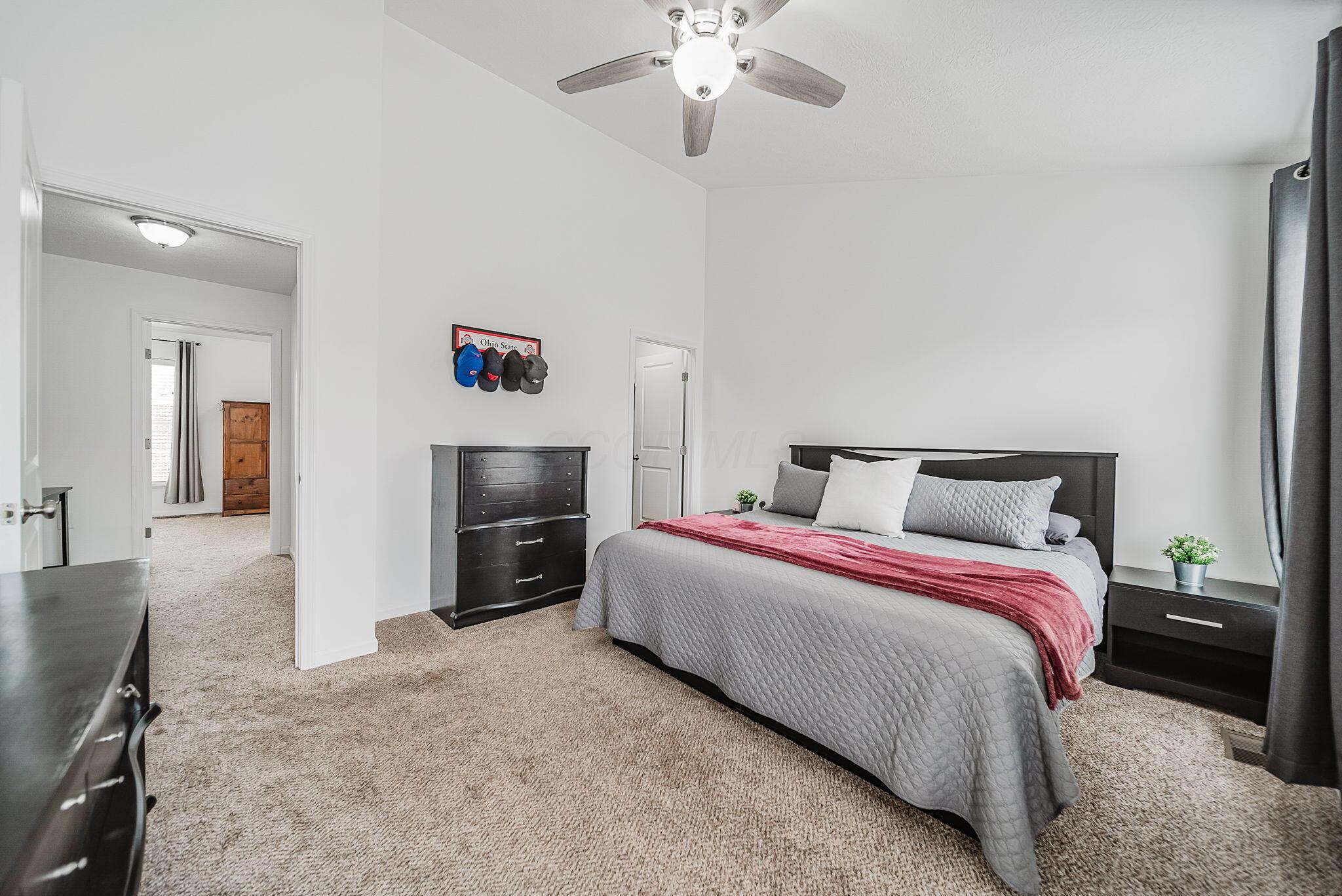 6186 Needletail Road, Unit 66 Columbus, OH 43230 - Photo 14 of 48 Bedroom #1 has vaulted ceilings, overhead lighting/fan, neutral decor, large walk-in closet, and generous en-suite bathroom!