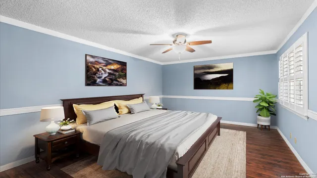 a bedroom with bed and wooden floor