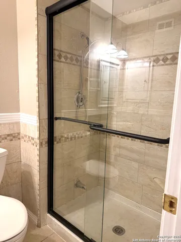 a bathroom with a glass shower door