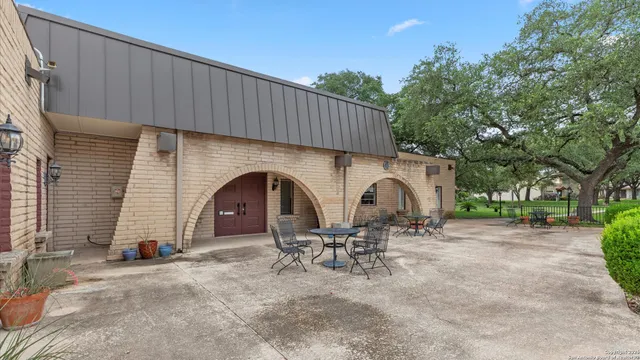 a backyard of a house with table and chairs