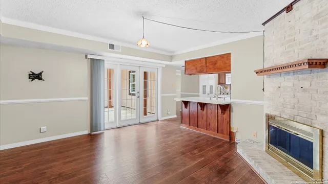 a view of kitchen with granite countertop cabinets and wooden floor