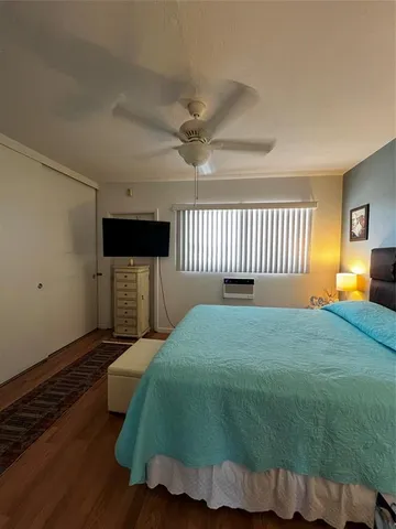 a bedroom with a bed and a television