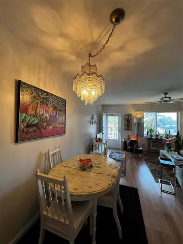 a view of a dining room with furniture and chandelier