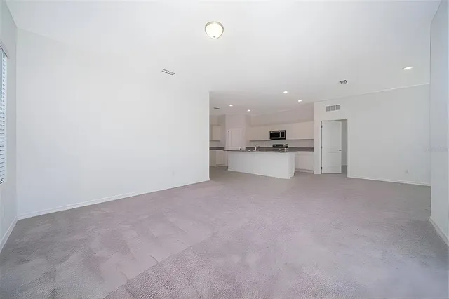 a view of a kitchen with a sink and cabinets