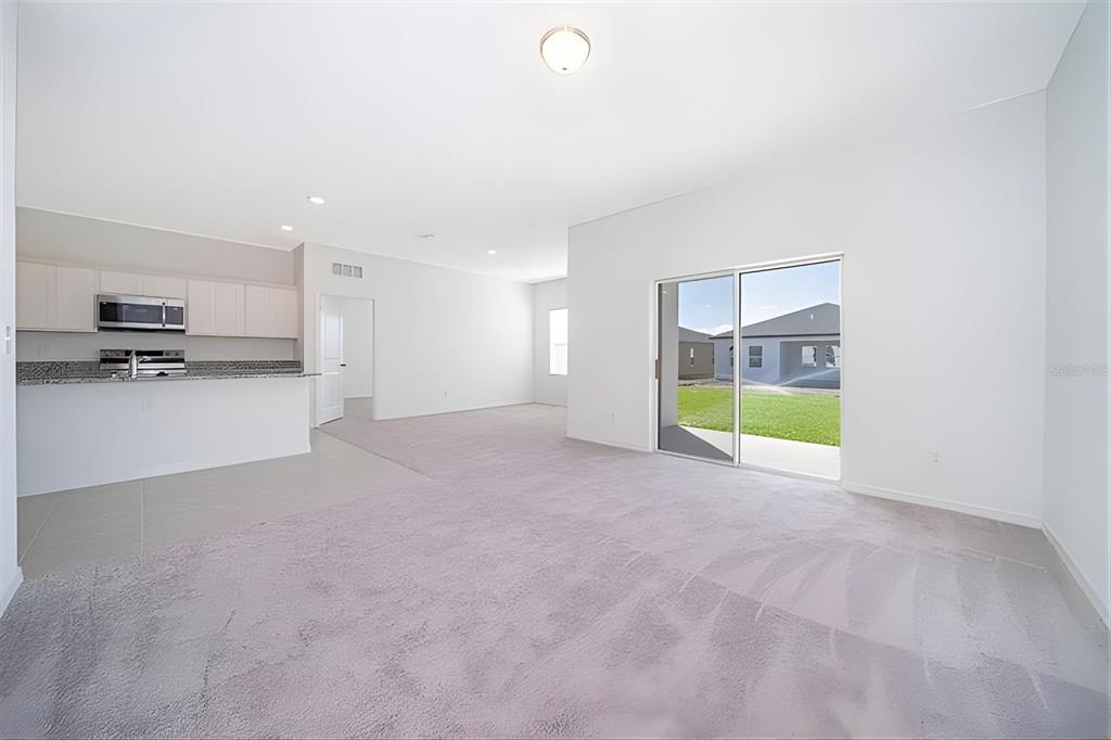 5844 Bovine Drive St. Cloud, FL 34771 - Photo 13 of 21 a view of an empty room with a kitchen