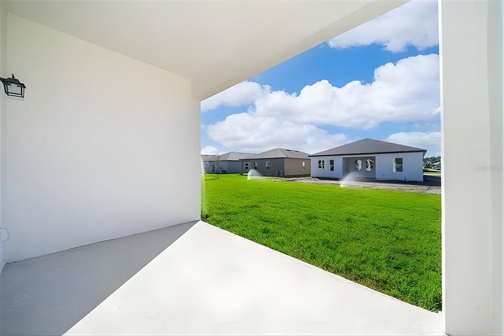 5844 Bovine Drive St. Cloud, FL 34771 - Photo 20 of 21 a view of a house with a big yard