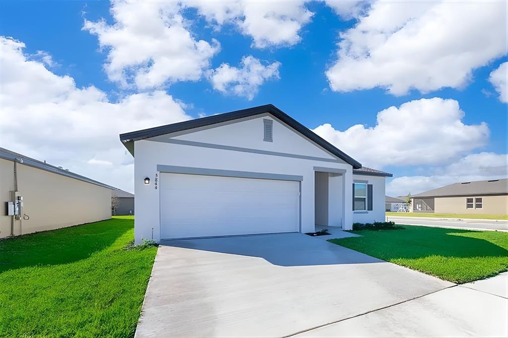 5844 Bovine Drive St. Cloud, FL 34771 - Photo 2 of 21 a front view of house with yard and green space
