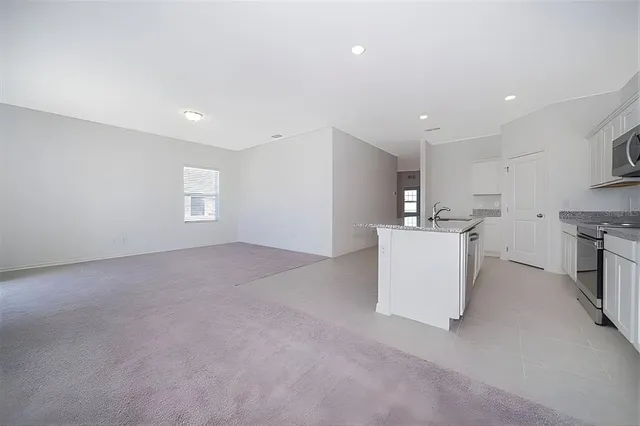 a view of a kitchen with microwave and cabinets
