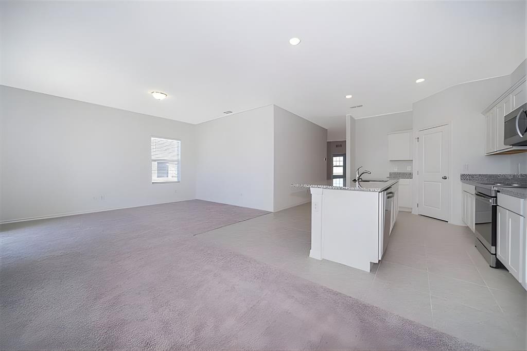 5844 Bovine Drive St. Cloud, FL 34771 - Photo 9 of 21 a view of a kitchen with microwave and cabinets