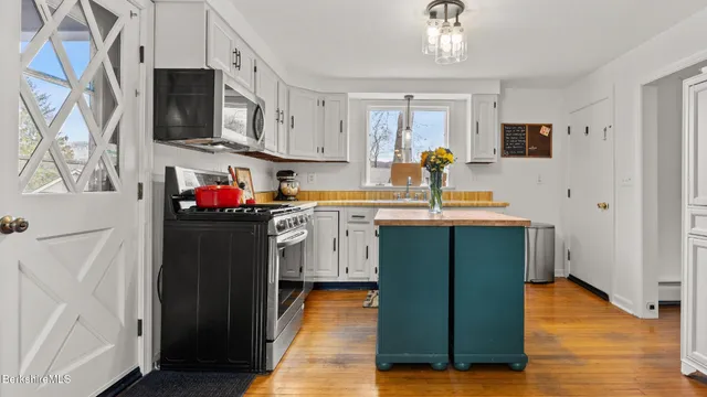 a kitchen with stainless steel appliances a refrigerator sink and cabinets