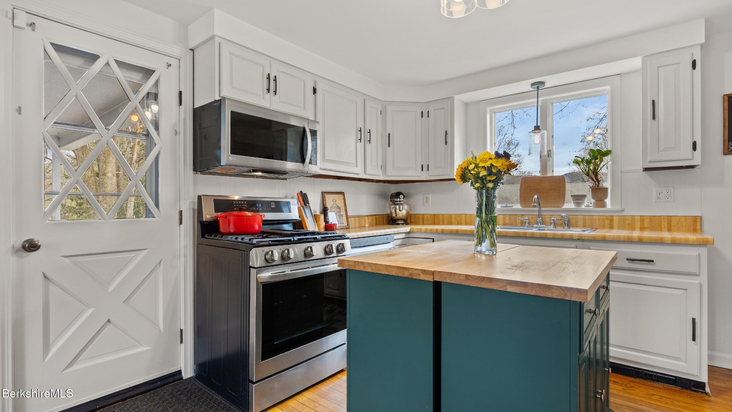 8 Catherine Street Lenox, MA 01242 - Photo 17 of 52 a kitchen with stainless steel appliances granite countertop a sink a stove and a refrigerator
