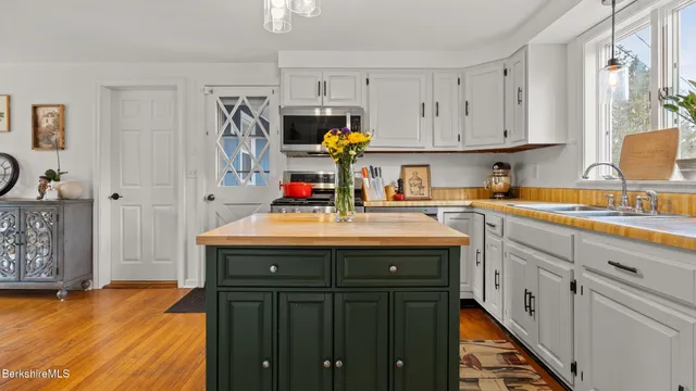 a kitchen with stainless steel appliances granite countertop a sink dishwasher and cabinets with wooden floor