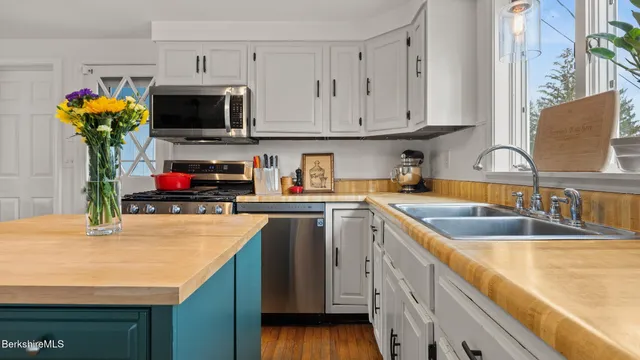 a kitchen with stainless steel appliances granite countertop a sink and a microwave
