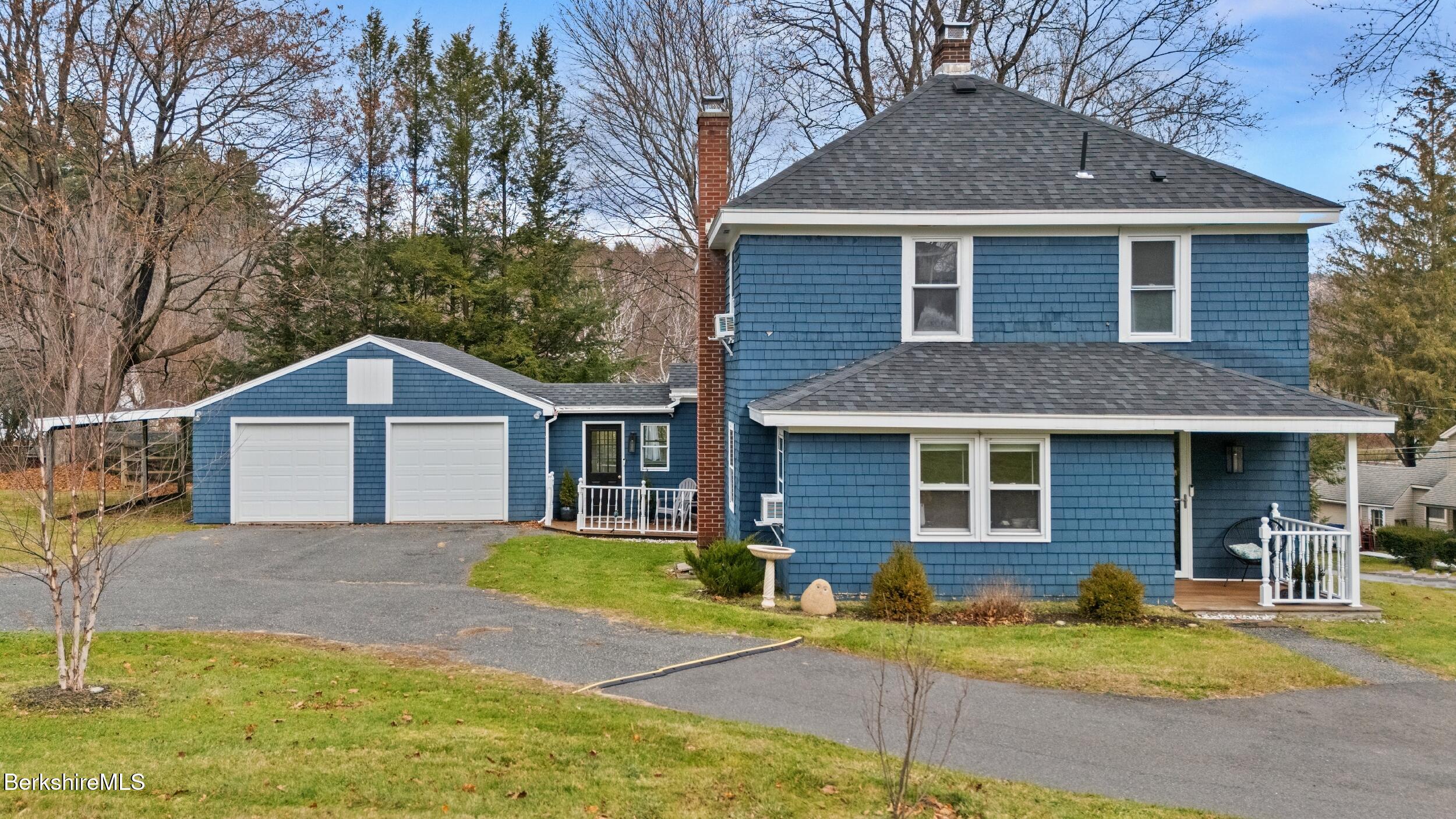 8 Catherine Street Lenox, MA 01242 - Photo 2 of 52 a front view of a house with a yard and garage