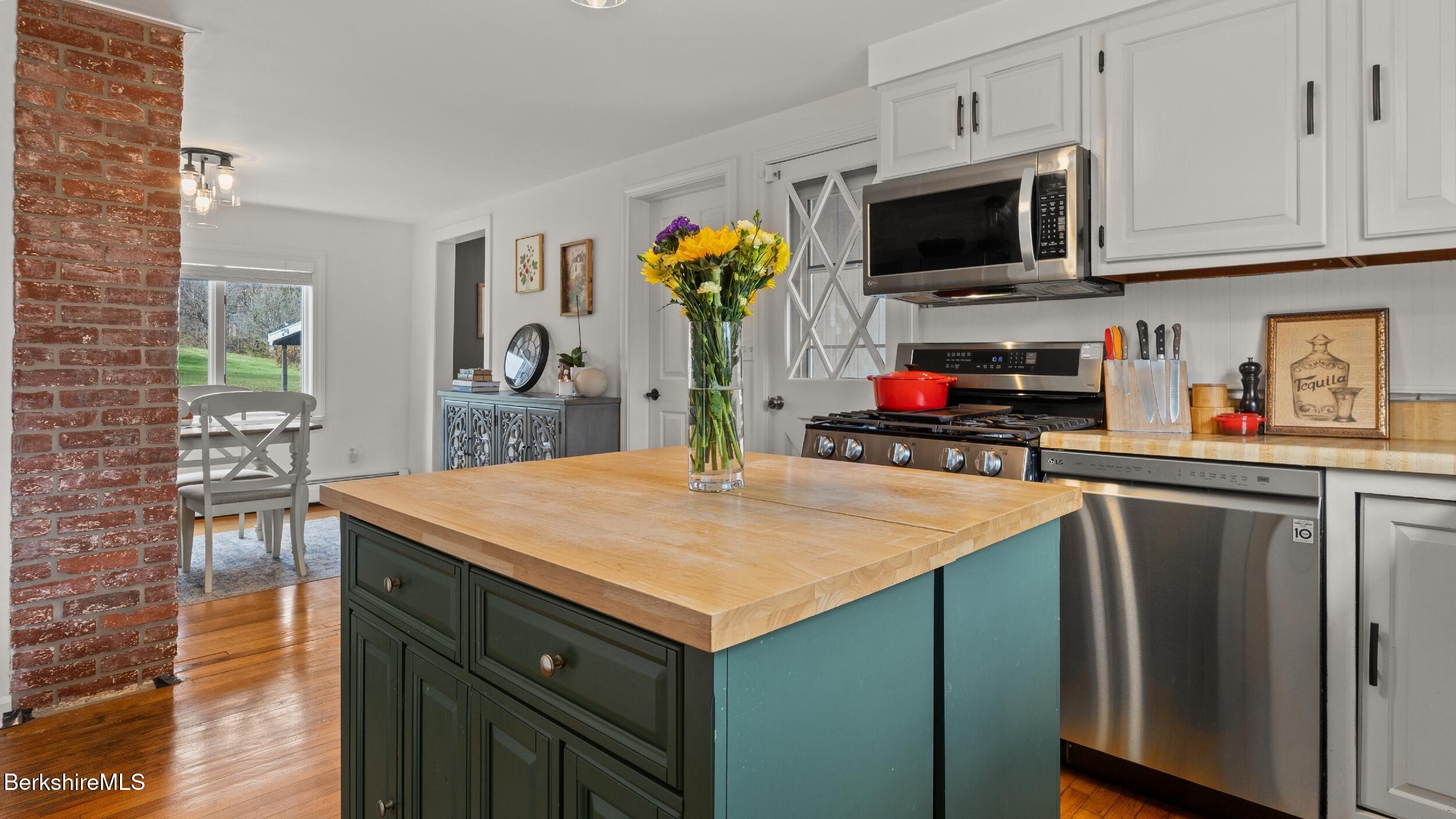 8 Catherine Street Lenox, MA 01242 - Photo 22 of 52 a kitchen with stainless steel appliances a stove microwave and cabinets