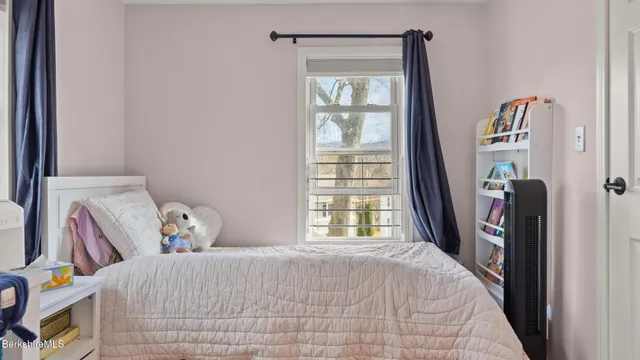 a bedroom with a bed and a window