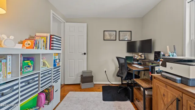 a bedroom with furniture and a book shelf