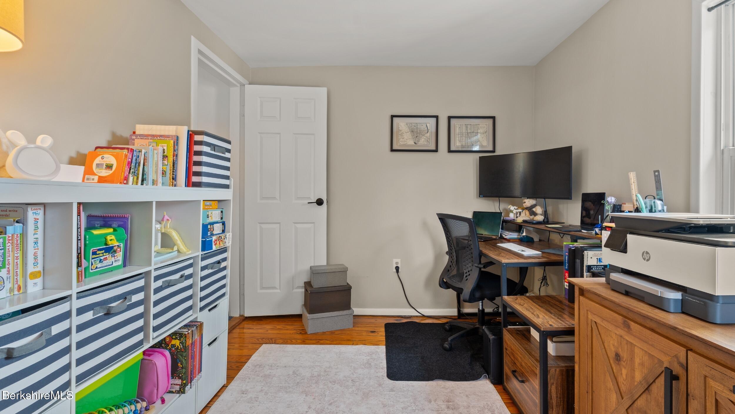 8 Catherine Street Lenox, MA 01242 - Photo 27 of 52 a bedroom with furniture and a book shelf
