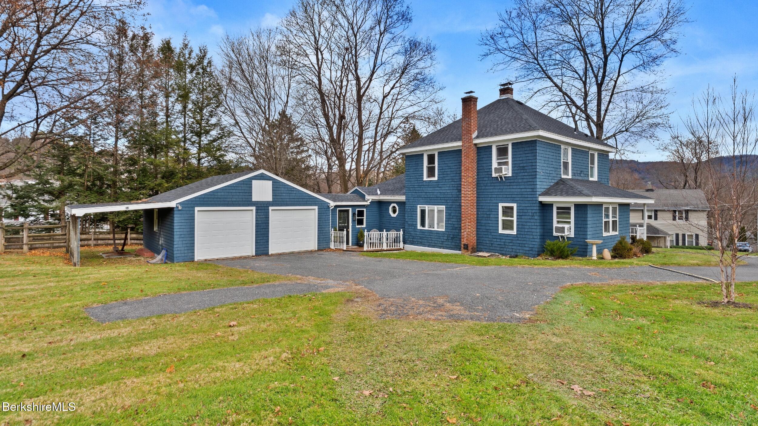8 Catherine Street Lenox, MA 01242 - Photo 3 of 52 a front view of a house with a yard