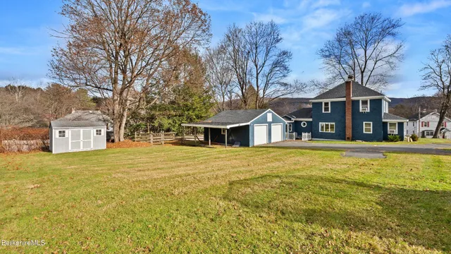 a front view of house with yard and trees