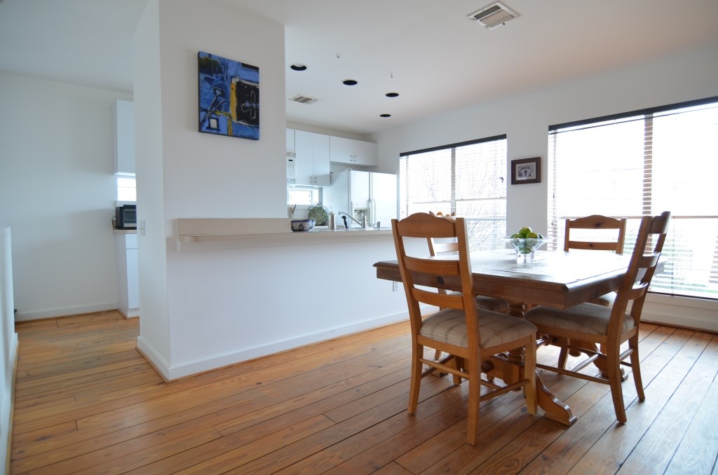 5401 Lillian Street Houston, TX 77007 - Photo 11 of 26 a view of a dining room with furniture and wooden floor