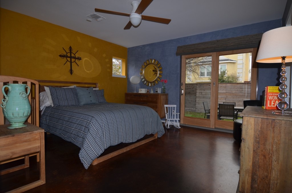 5401 Lillian Street Houston, TX 77007 - Photo 16 of 26 a bedroom with a bed and wooden floor