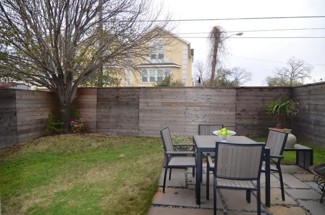 a view of a chairs and table in backyard