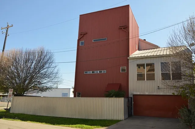 a front view of a house with trees