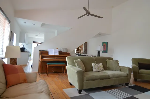 a living room with furniture a couch and a window