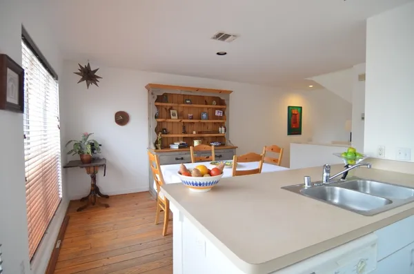 a kitchen with a sink and a stove top oven