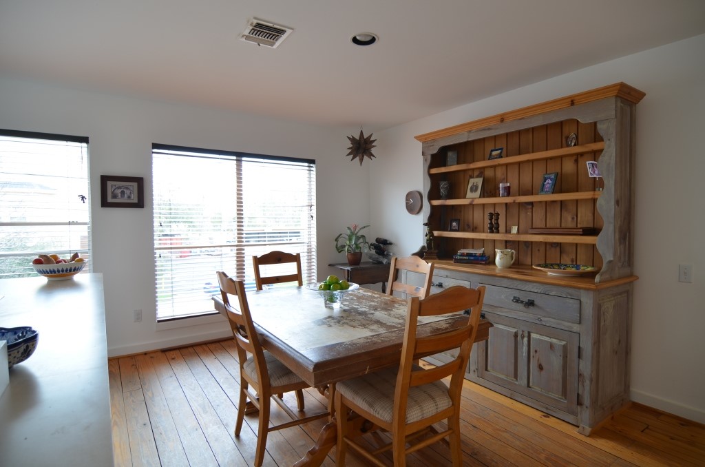 5401 Lillian Street Houston, TX 77007 - Photo 10 of 26 a view of a dining room with furniture window and wooden floor