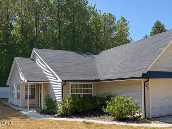 a backyard of a house with plants and trees