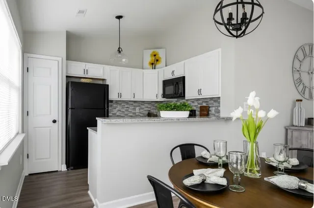 a kitchen with stainless steel appliances granite countertop a refrigerator and a stove top oven