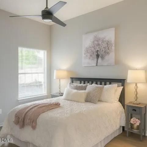 a bedroom with a bed and a painting on the wall