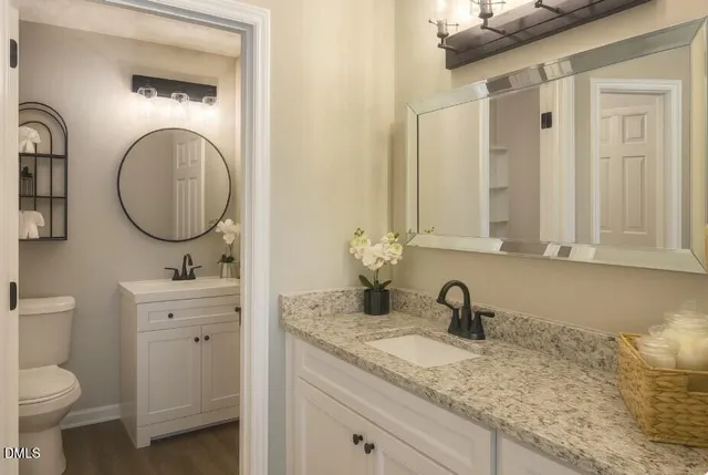 a bathroom with a granite countertop sink and a mirror