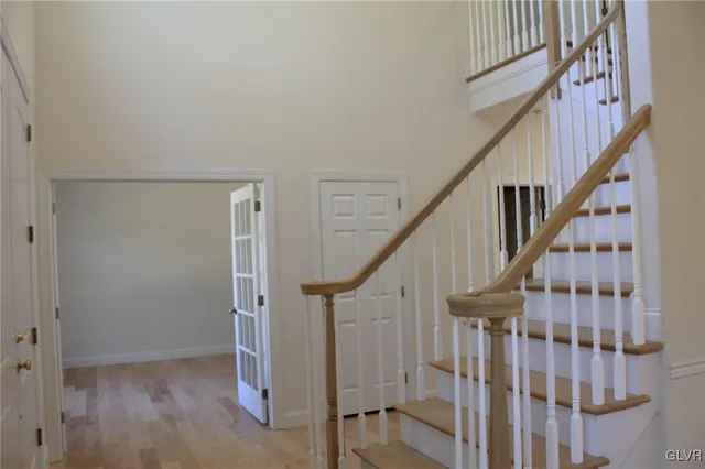 a view of staircase with railing and white walls